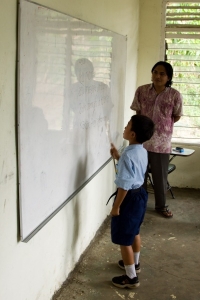 Balinese boy learning to read, Pengulusan school